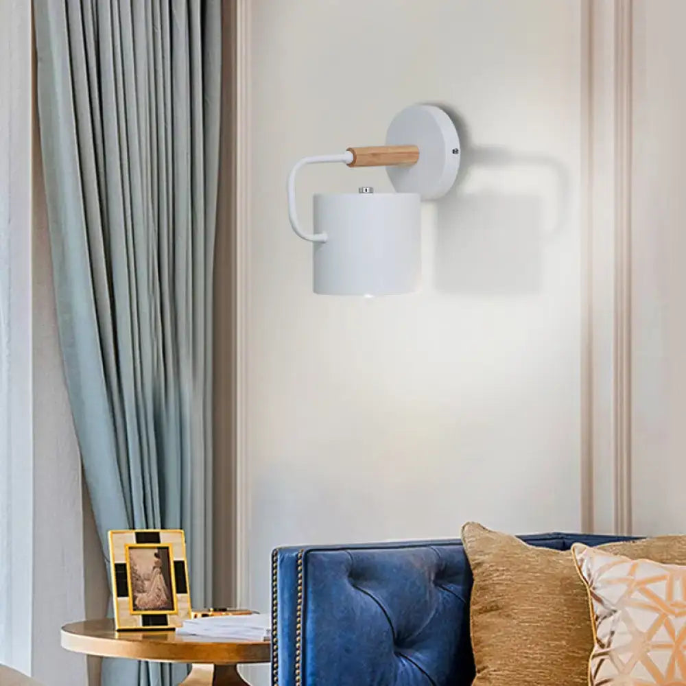 Gray metal wall sconce by Decorbites with white cylindrical shade and wood-accent arm on Tampa Home & Garden Store