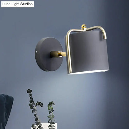 Green gray metal wall sconce with cylindrical gray shade and brass-accented frame Decorbites on Tampa Home & Garden Store