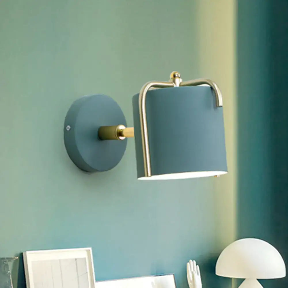 Green gray metal sconce with brass accent on teal wall by Decorbites on Tampa Home & Garden Store