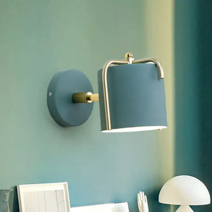 Green gray metal sconce with brass accent on teal wall by Decorbites on Tampa Home & Garden Store