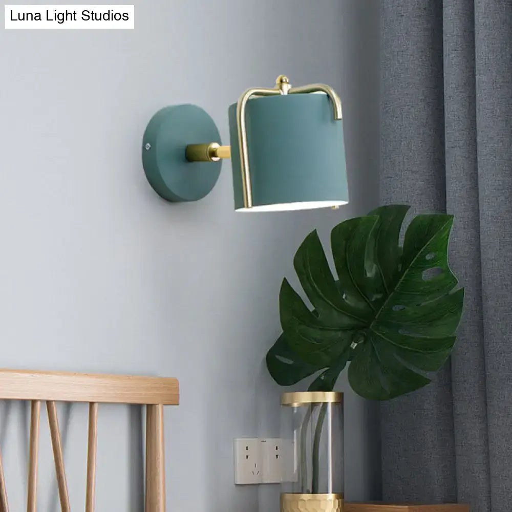 Green gray metal sconce with brass frame and teal shade mounted on wall on Tampa Home & Garden Store