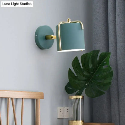 Green gray metal sconce with brass frame and teal shade mounted on wall on Tampa Home & Garden Store