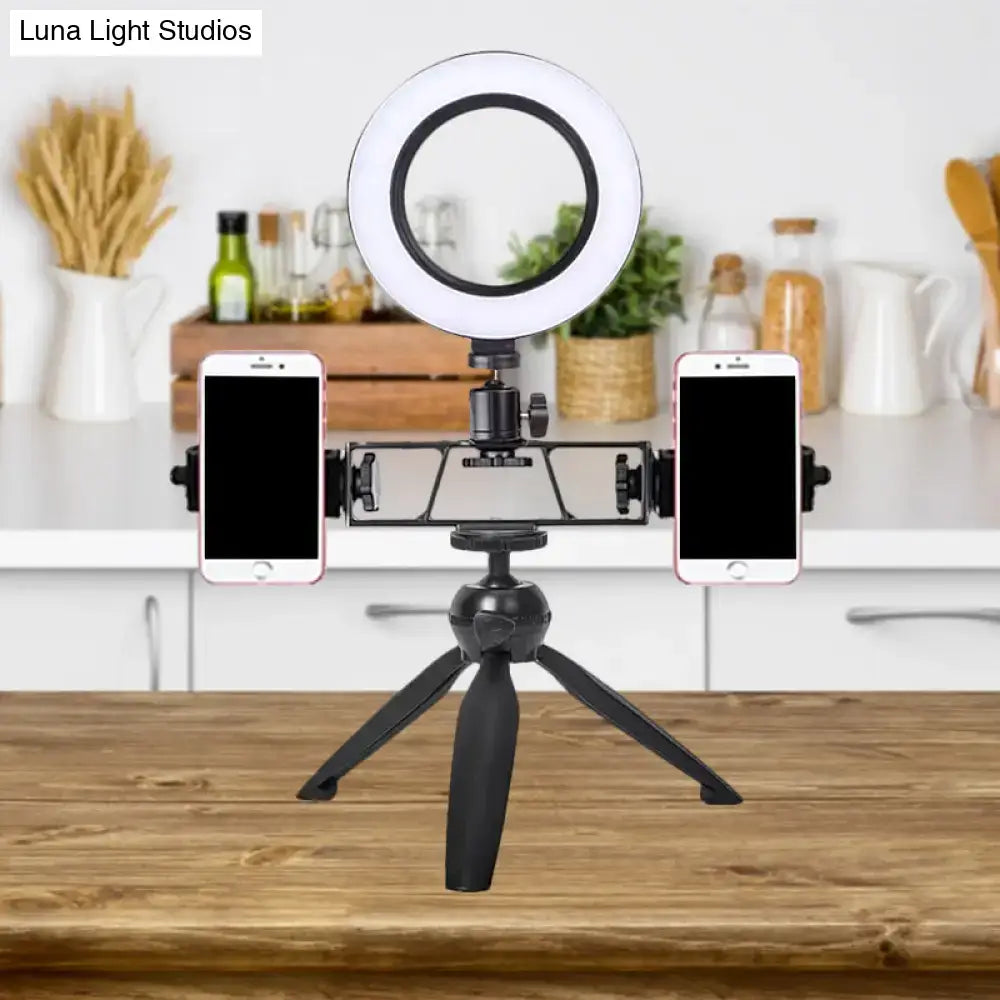 Black Decorbites LED ring light with dual phone mounts on a tabletop stand in a kitchen on Tampa Home & Garden Store