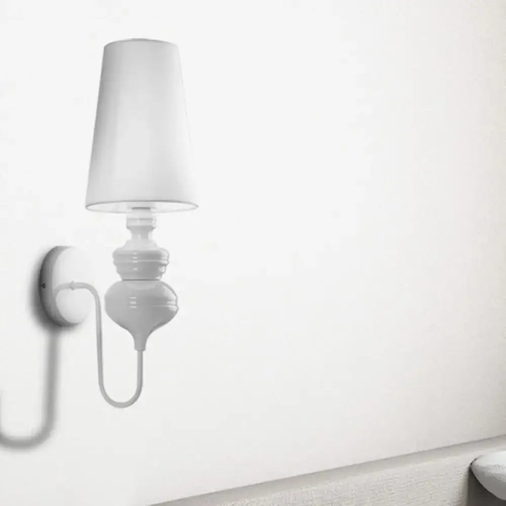 White fabric shade wall sconce with ceramic pedestal and curved arm on wall on Tampa Home & Garden Store