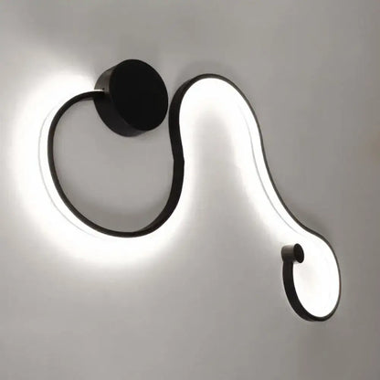 Black White Twist Sconce by Decorbites; curved LED loop with black metal frame and circular wall plate on Tampa Home & Garden Store