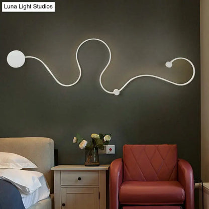 Decorbites Black White Twist Sconce, white curved line wall light mounted on dark wall on Tampa Home & Garden Store