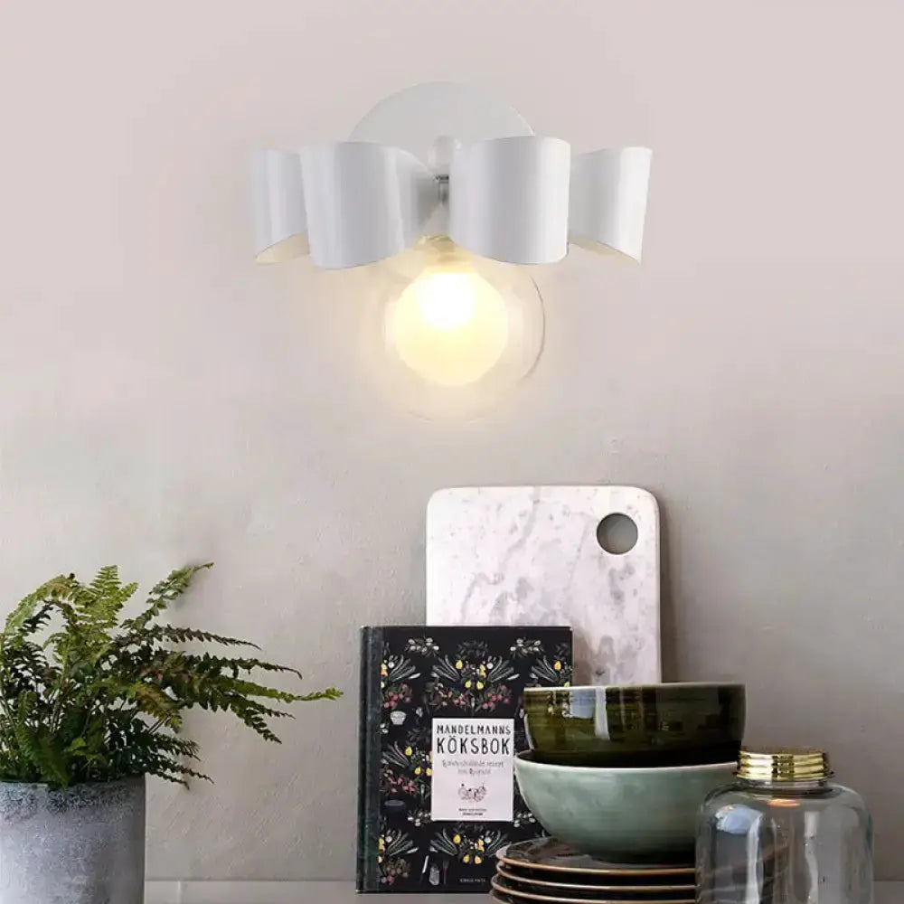 Contemporary white ceramic petal wall lamp with round glass bulb for bedroom on Tampa Home & Garden Store