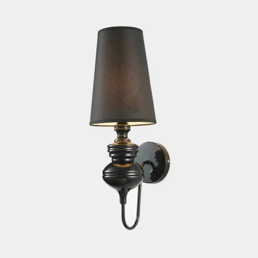 Wall sconce with glossy black ceramic base and tall tapered shade on Tampa Home & Garden Store