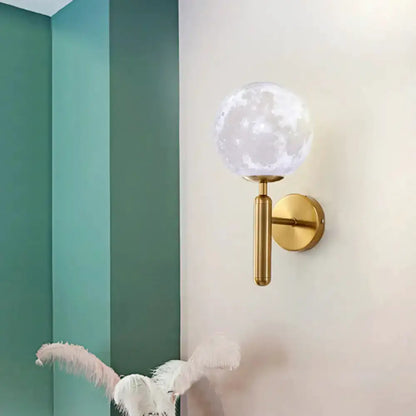 Contemporary white glass wall sconce with gold moon-style globe and brass mount Decorbites on Tampa Home & Garden Store