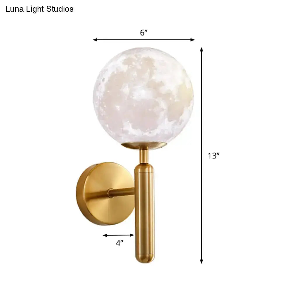 Gold finish contemporary wall sconce with a white glass moon globe and cylindrical stem on Tampa Home & Garden Store