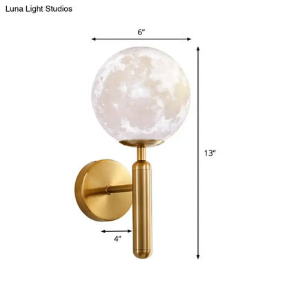 Gold finish contemporary wall sconce with a white glass moon globe and cylindrical stem on Tampa Home & Garden Store