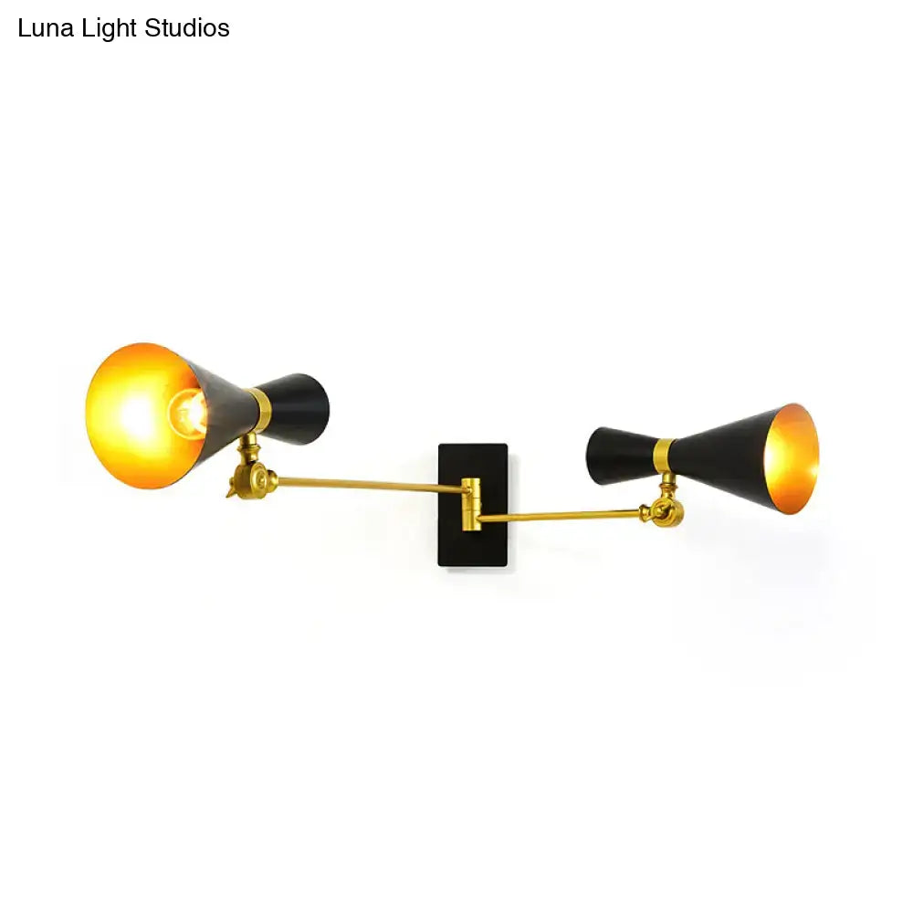 Gold adjustable arm wall sconce with dual black cone shades and black backplate on Tampa Home & Garden Store