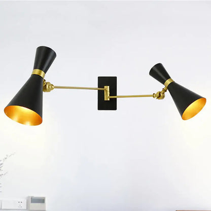 Decorbites two-light gold adjustable arm wall sconce with black shades on a backplate on Tampa Home & Garden Store
