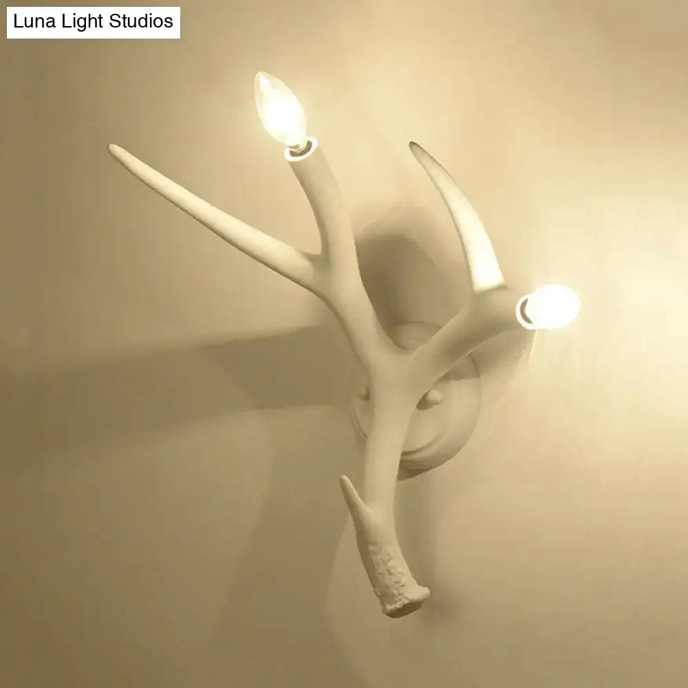 White resin antler sconce by Decorbites with two candle bulbs, wall-mounted decor on Tampa Home & Garden Store