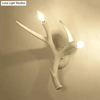 White resin antler sconce by Decorbites with two candle bulbs, wall-mounted decor on Tampa Home & Garden Store