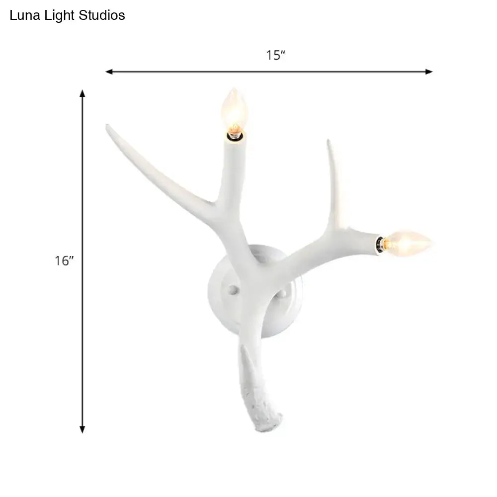 White resin antler wall sconce by Decorbites with two candle bulbs on Tampa Home & Garden Store