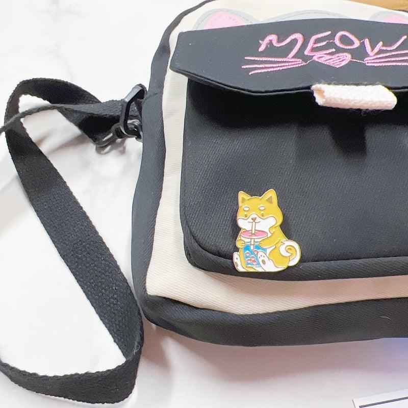 Corgi Drinking Boba enamel pin by Shaketea on a black canvas crossbody bag on Tampa Home & Garden Store