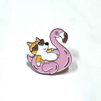 Corgi Flamingo Floatie enamel pin by Shaketea with a pink flamingo and lounging corgi on Tampa Home & Garden Store