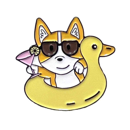 Corgi Floaty enamel pin by Shaketea; yellow corgi in sunglasses inside a pool float with duck on Tampa Home & Garden Store
