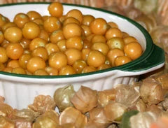 Cossack Pineapple Tomatillo seeds: yellow-orange tomatillos in a white dish with green rim on Tampa Home & Garden Store