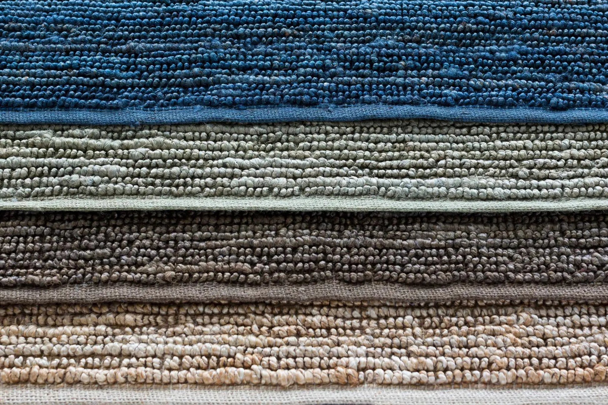 Glover Bleached Braided Jute Carpet rug stacked in blue gray taupe and beige tones on Tampa Home & Garden Store