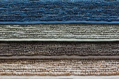 Glover Bleached Braided Jute Carpet rug stacked in blue gray taupe and beige tones on Tampa Home & Garden Store