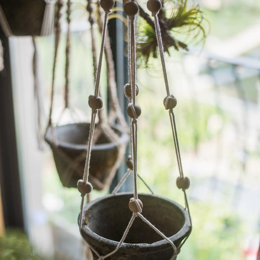 Cotton Hemp Rope Planter Hanger by RusticReach with wooden bead accents suspending a clay pot on Tampa Home & Garden Store
