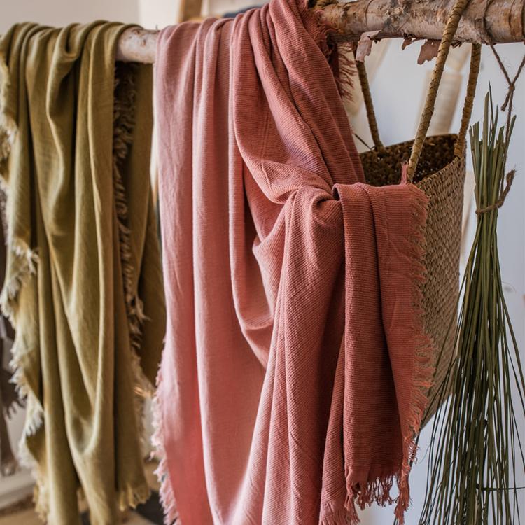 Cotton throw sofa blanket in olive green and dusty rose, draped over wood rod, 3 blankets on Tampa Home & Garden Store