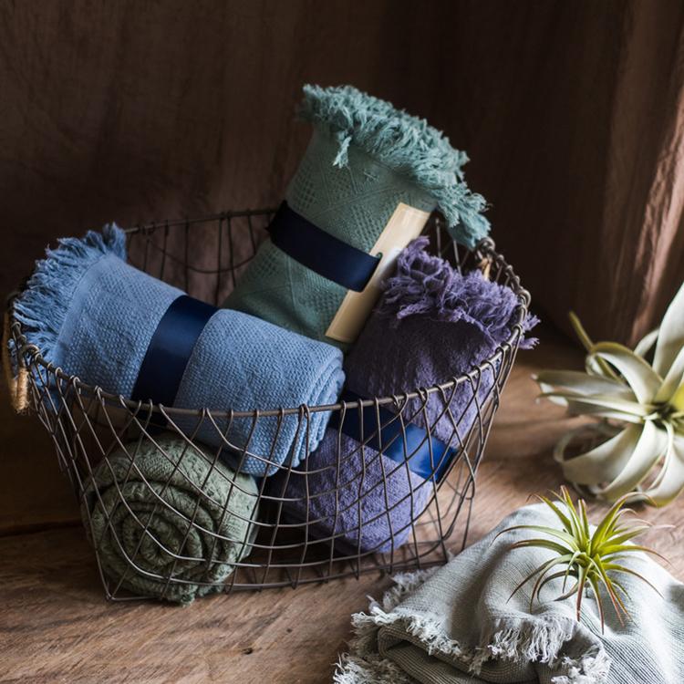 Cotton Throw Sofa Blanket set by RusticReach in blue, sage, and plum (set of 4) in a wire basket on Tampa Home & Garden Store