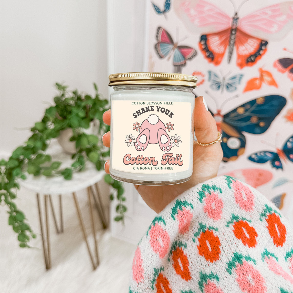 Cotton Blossom Retro Candle held in hand in glass jar with gold lid Gia Roma Cotton Tail on Tampa Home & Garden Store