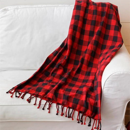 Red buffalo plaid throw blanket by Gia Roma with fringed tassels on a white sofa on Tampa Home & Garden Store