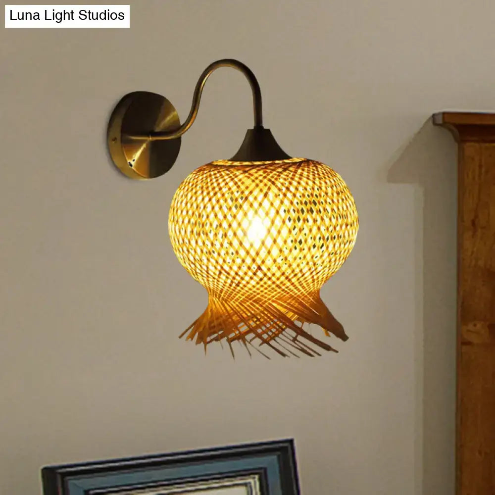 Beige rattan wall sconce with woven shade, curved metal arm, round backplate by Decorbites on Tampa Home & Garden Store