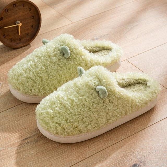 Pair of mint-green plush fur slippers with fluffy interior and white sole on Tampa Home & Garden Store