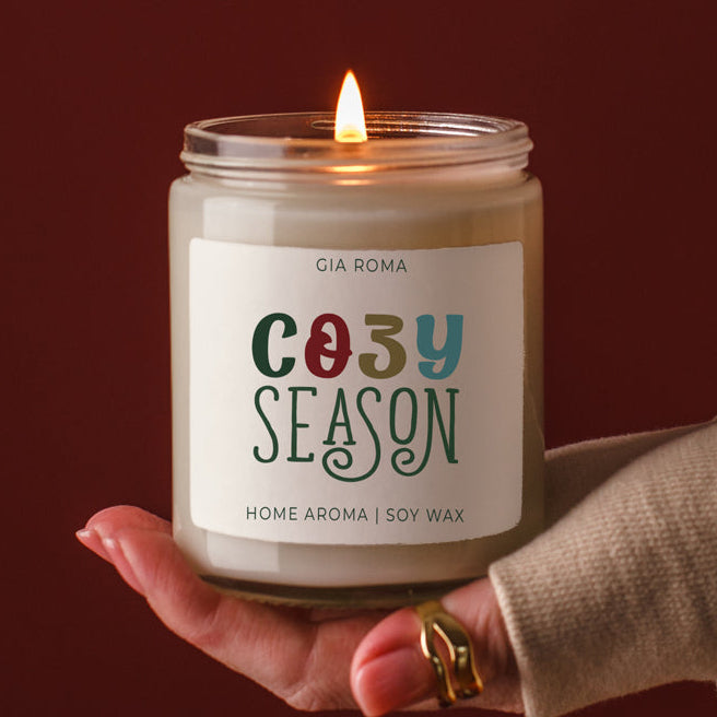 Cozy Season candle by Gia Roma in a glass jar with a lit wick and colorful label soy wax on Tampa Home & Garden Store