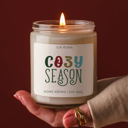 Cozy Season candle by Gia Roma in a glass jar with a lit wick and colorful label soy wax on Tampa Home & Garden Store