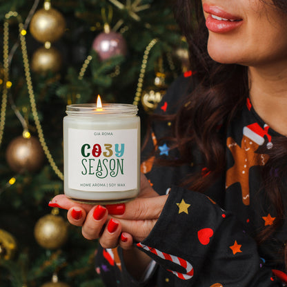 Cozy Season Candle by Gia Roma, soy wax in a clear glass jar, lit for festive mood on Tampa Home & Garden Store
