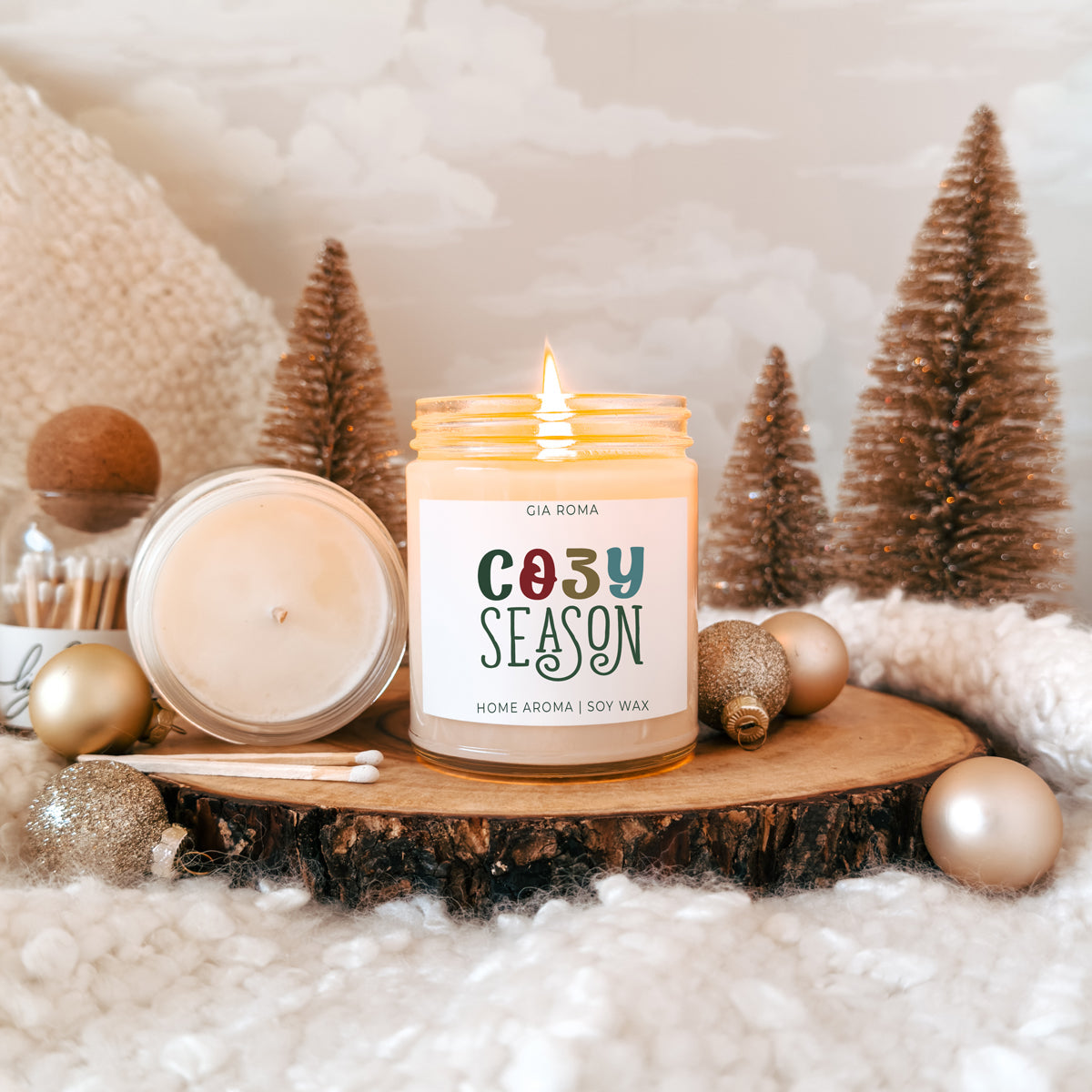 Cozy Season Candle by Gia Roma, cream soy wax, warm lit jar on wood slice with decor on Tampa Home & Garden Store