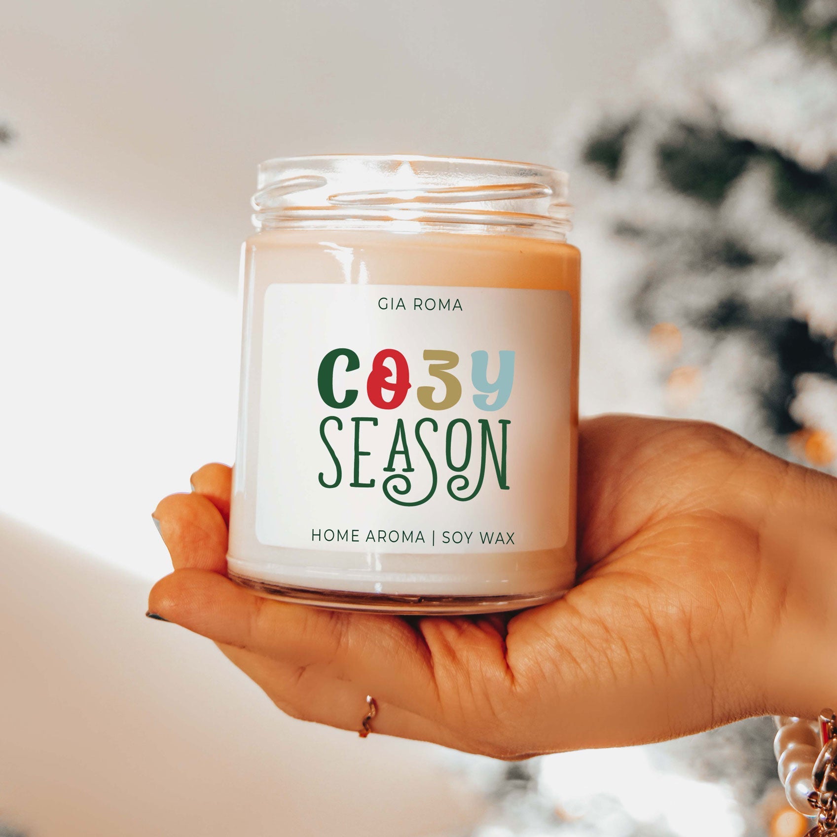 Cozy Season Candle by Gia Roma, peach soy wax in clear jar, held in hand on Tampa Home & Garden Store