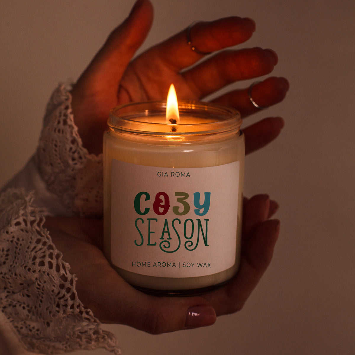 Cozy Season candle Gia Roma in a glass jar with warm flame, soy wax, hand held in lace sleeve on Tampa Home & Garden Store
