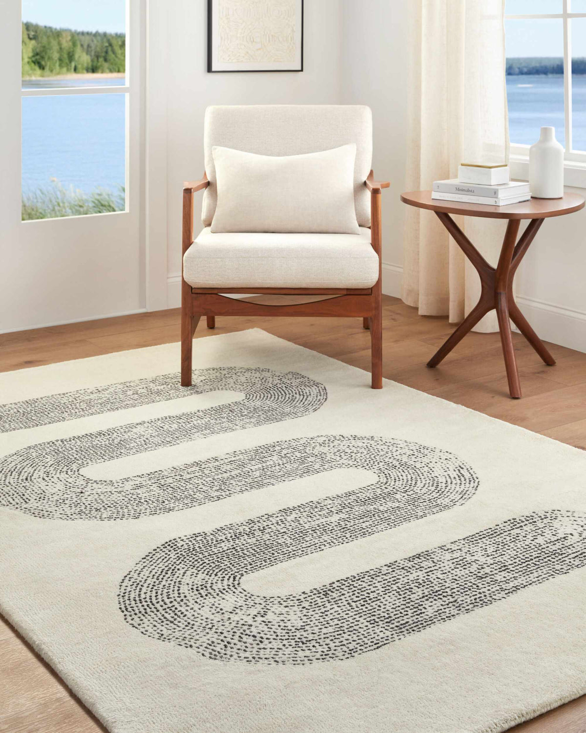 Saura Wool Area Rug by Boutique Rugs, cream with black swirl pattern in living room setting on Tampa Home & Garden Store