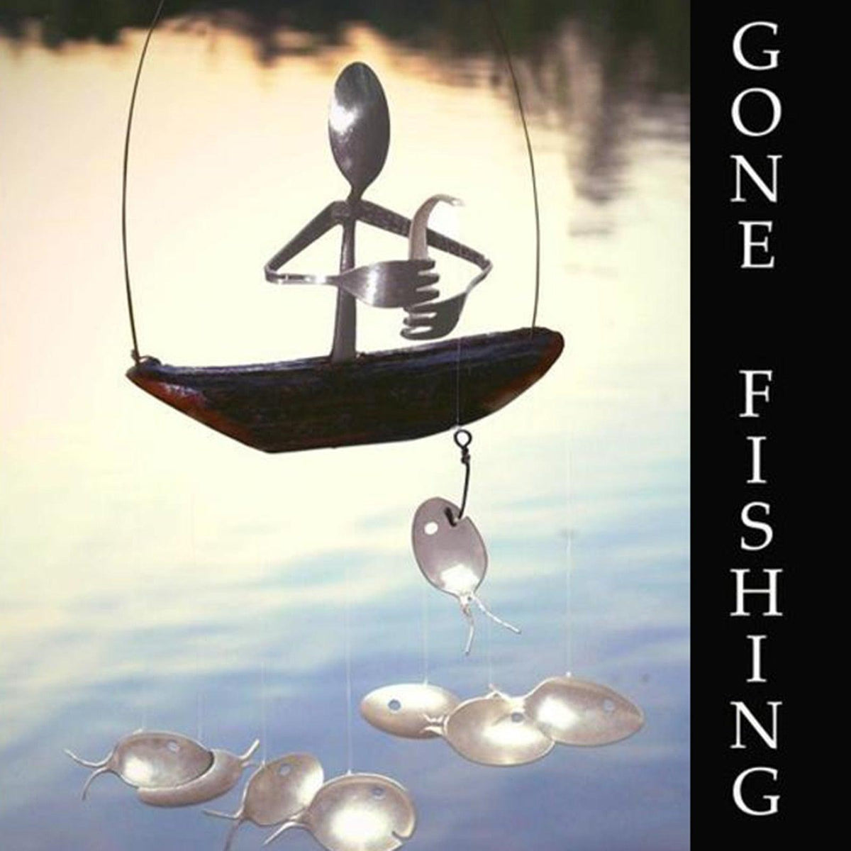 Wind chime fishing man spoon sculpture by Stevvex on a wooden boat base with metal fish on Tampa Home & Garden Store