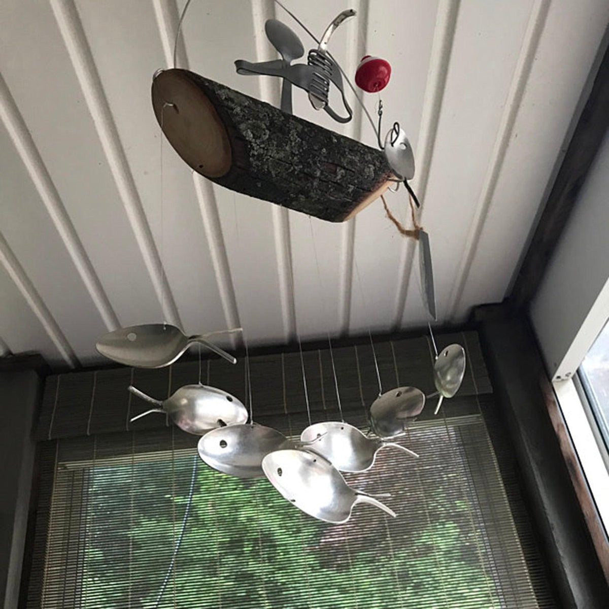 Creative Fishing Man Spoon Fish Wind Chime with rustic log centerpiece and fish accents on Tampa Home & Garden Store