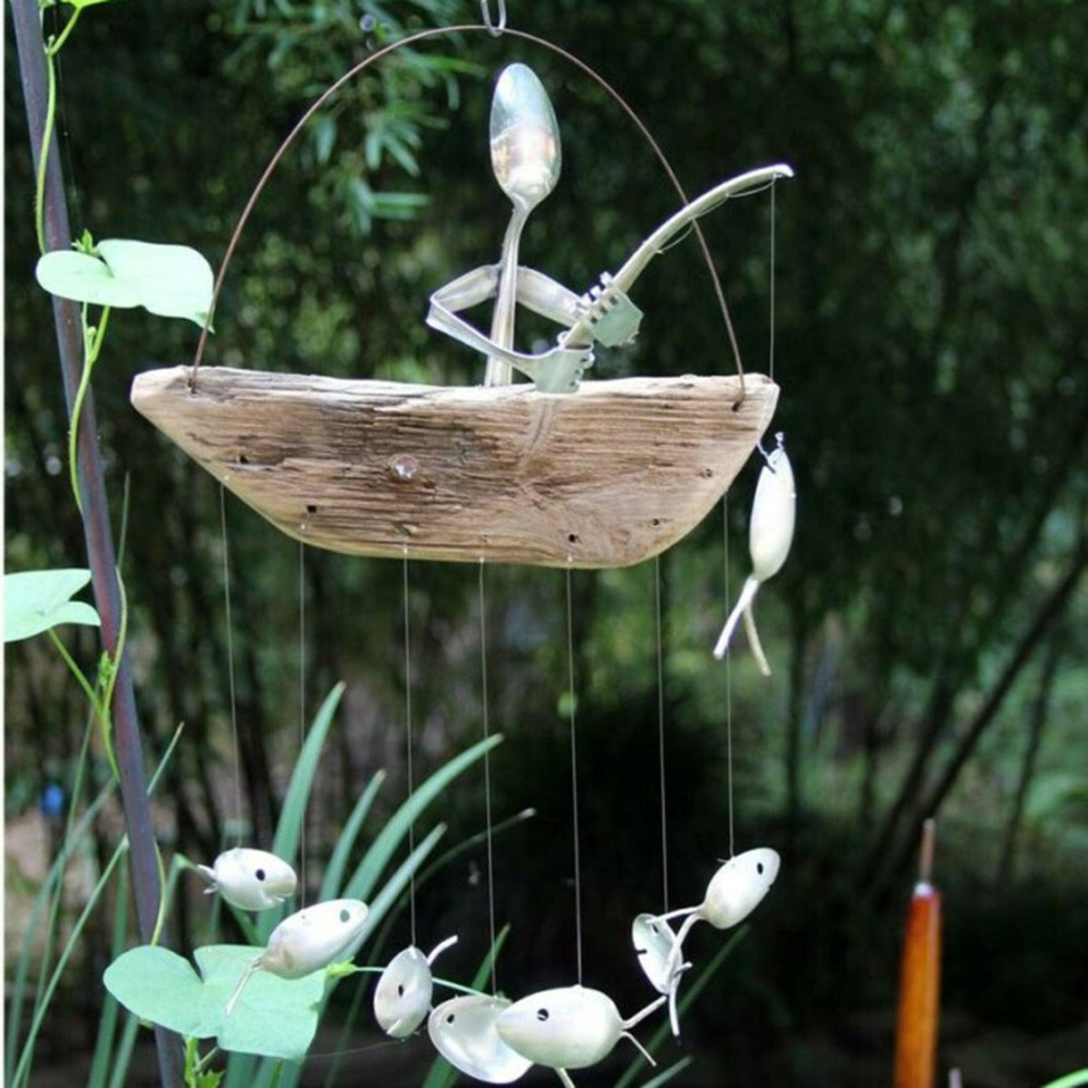 Stevvex wind chime fishing man sculpture on rustic driftwood boat with spoonfish beads on Tampa Home & Garden Store