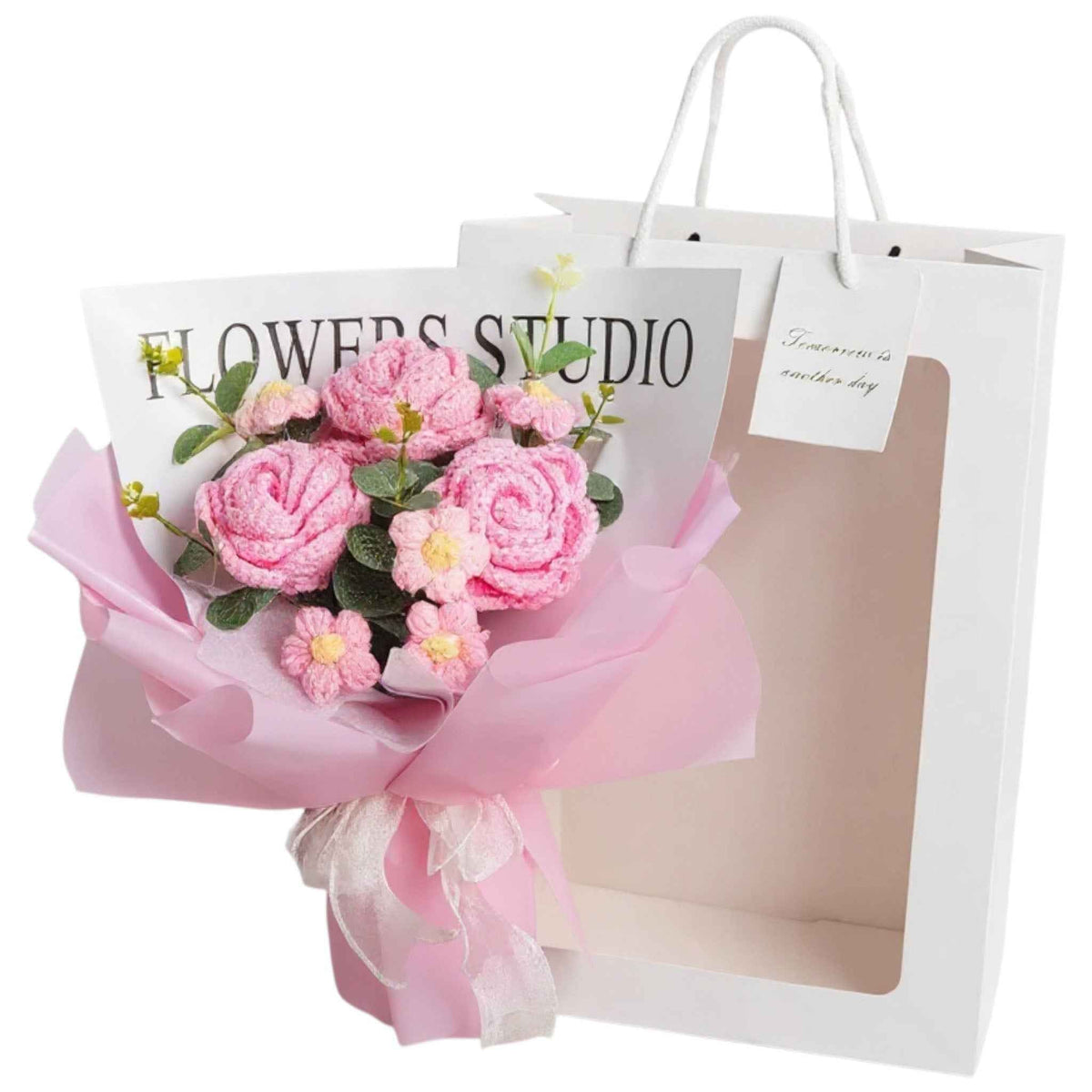 Crochet rose bouquet with LED light in pink hues, wrapped in pink tissue beside a white gift bag on Tampa Home & Garden Store
