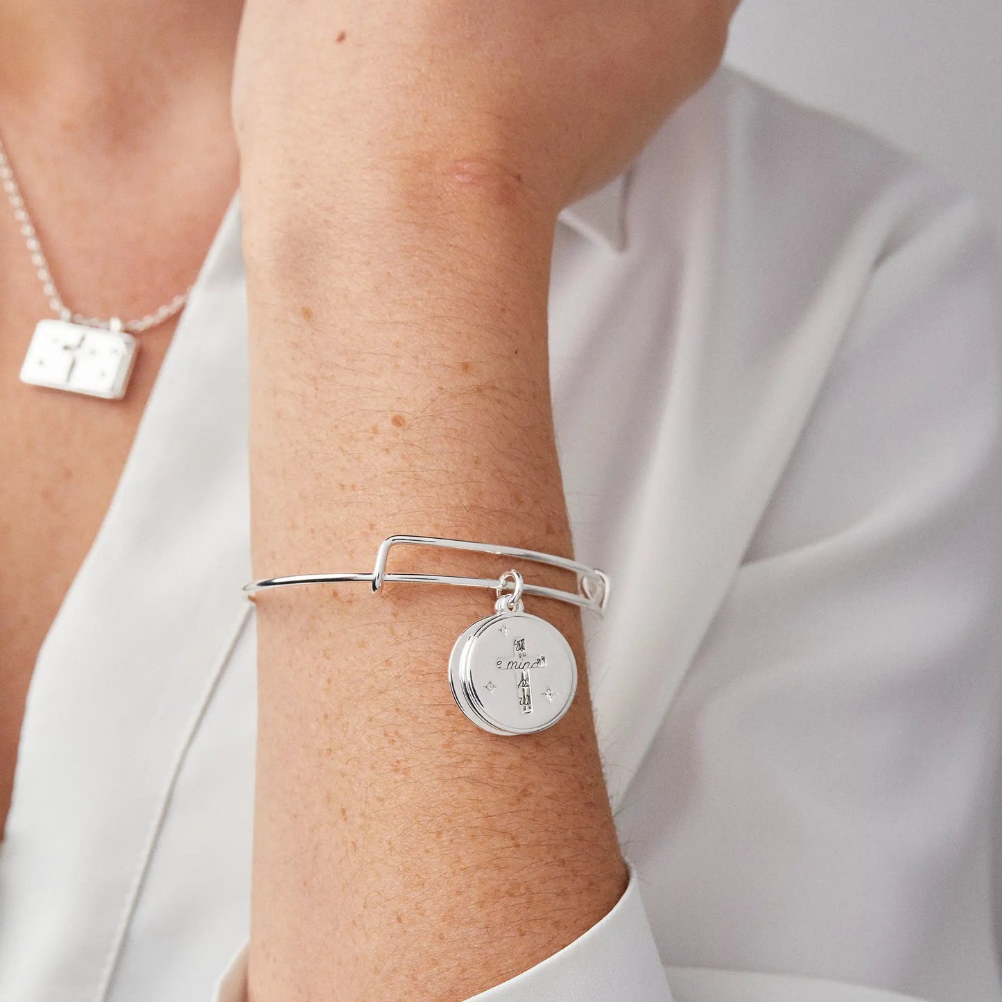 Hidden Message Cross Affirmation Bangle by Alex and Ani, silver with round pendant on wrist on Tampa Home & Garden Store