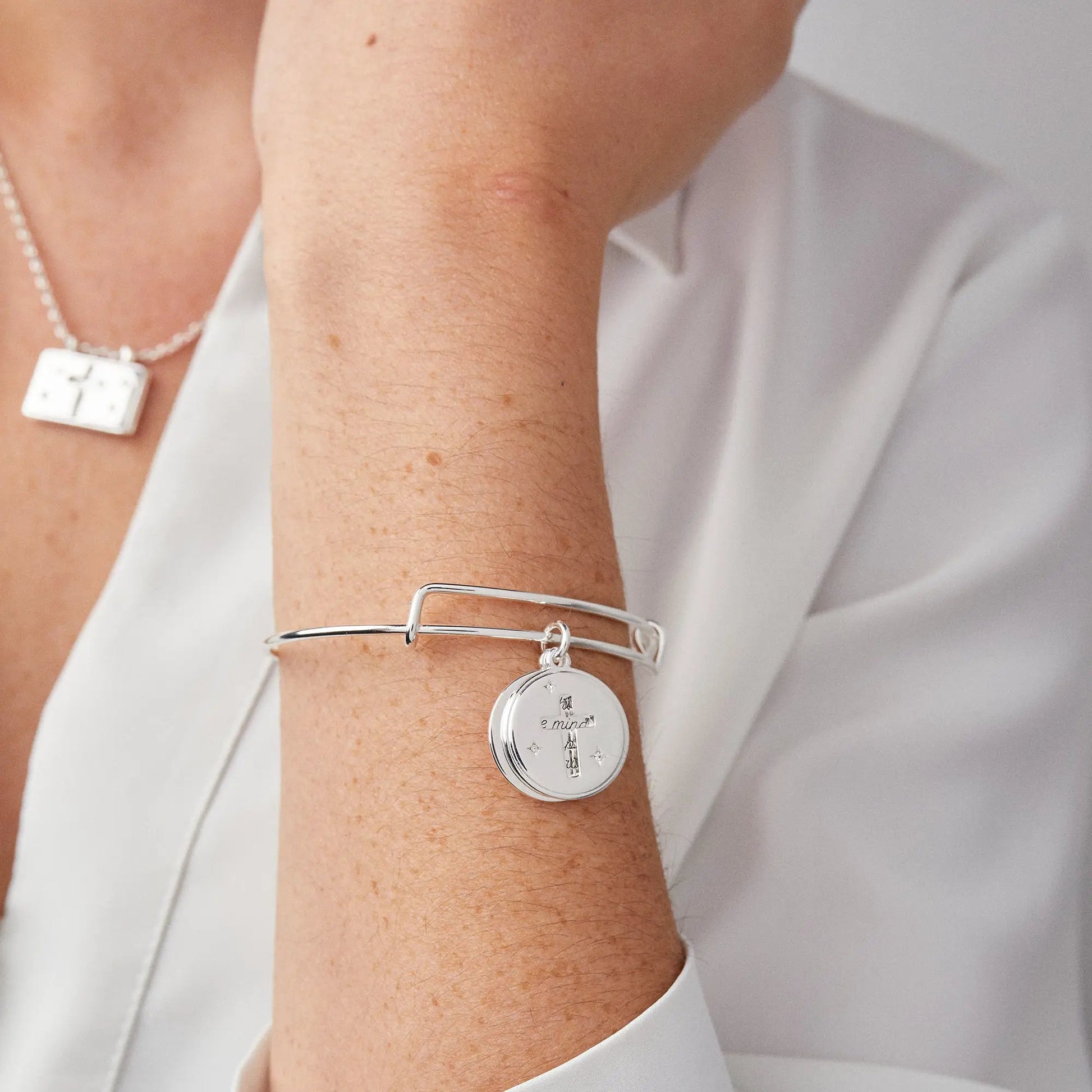 Hidden Message Cross Affirmation Bangle by Alex and Ani, silver with round pendant on wrist on Tampa Home & Garden Store