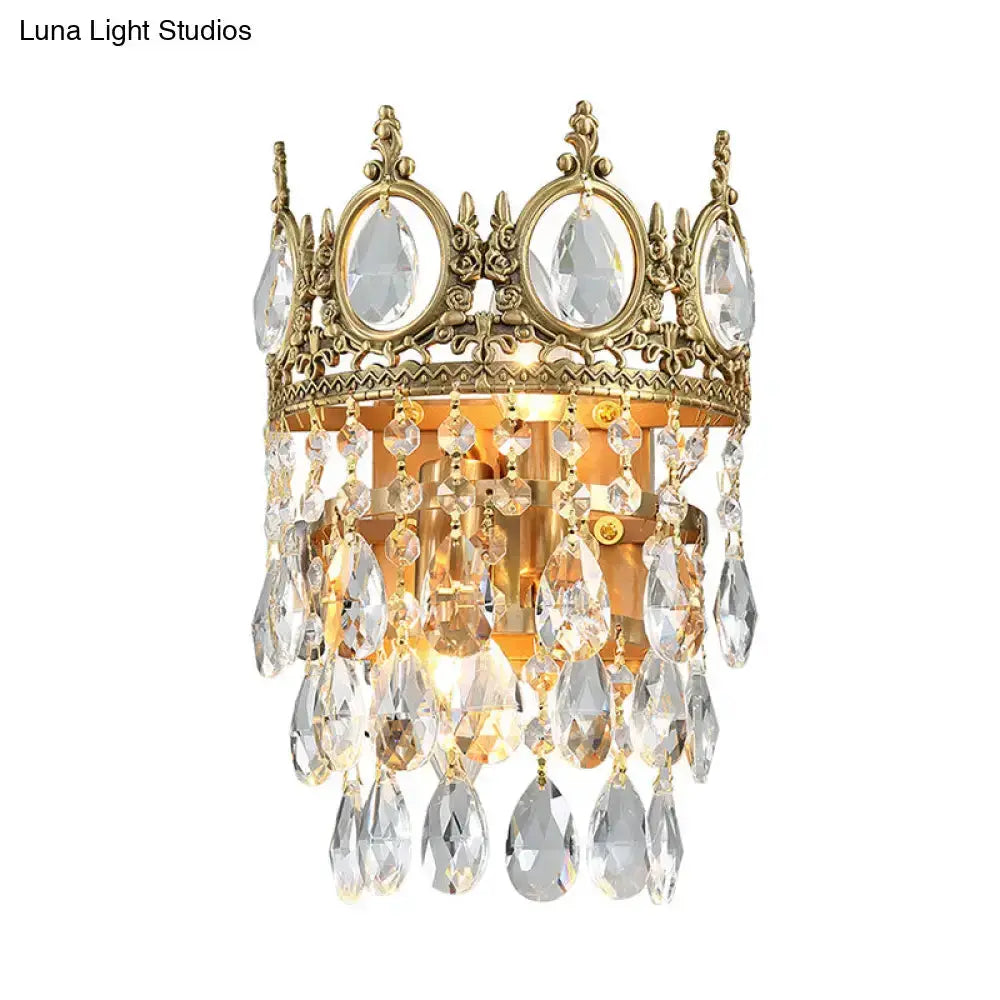 Crown aged brass wall-mounted sconce with clear crystal prisms and hanging droplets Decorbites bedroom lighting on Tampa Home & Garden Store