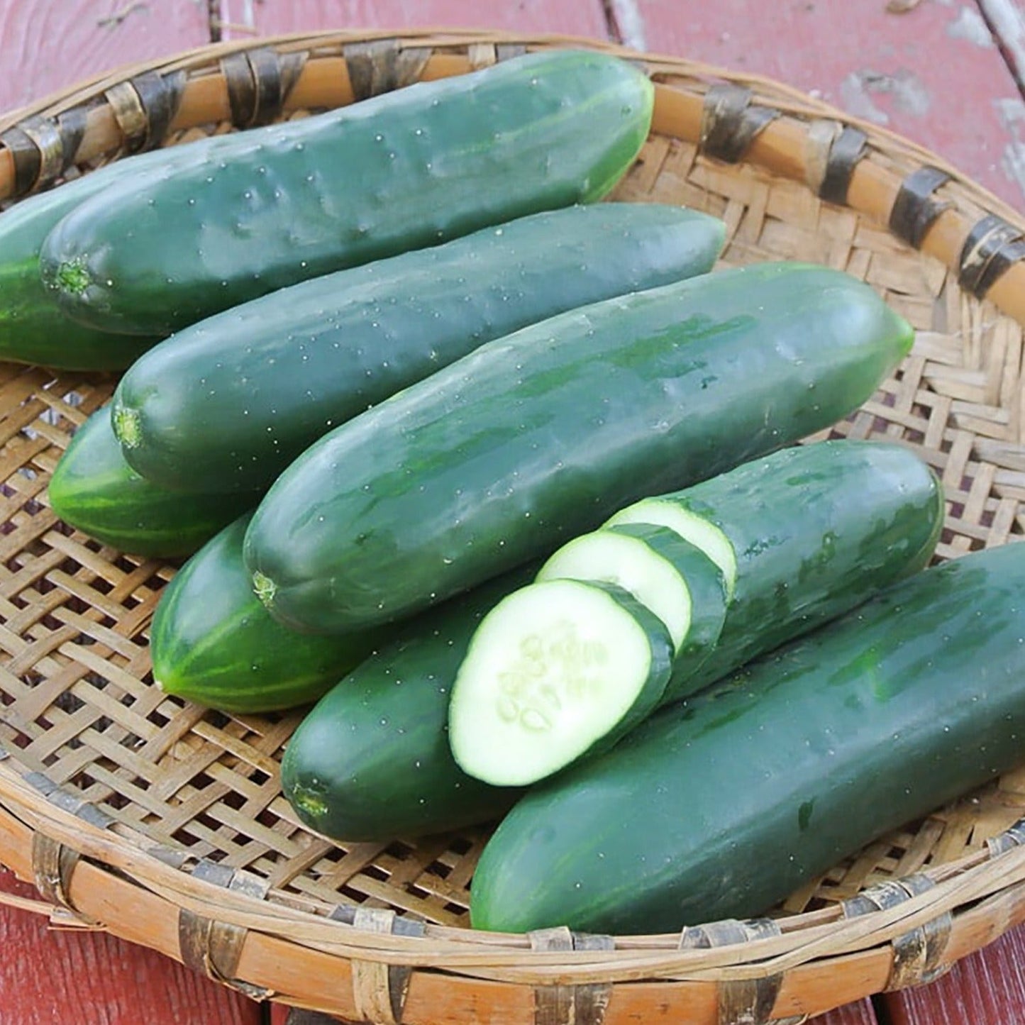 Poinsett 76 cucumber in basket; several dark-green cucumbers with sliced piece on Tampa Home & Garden Store