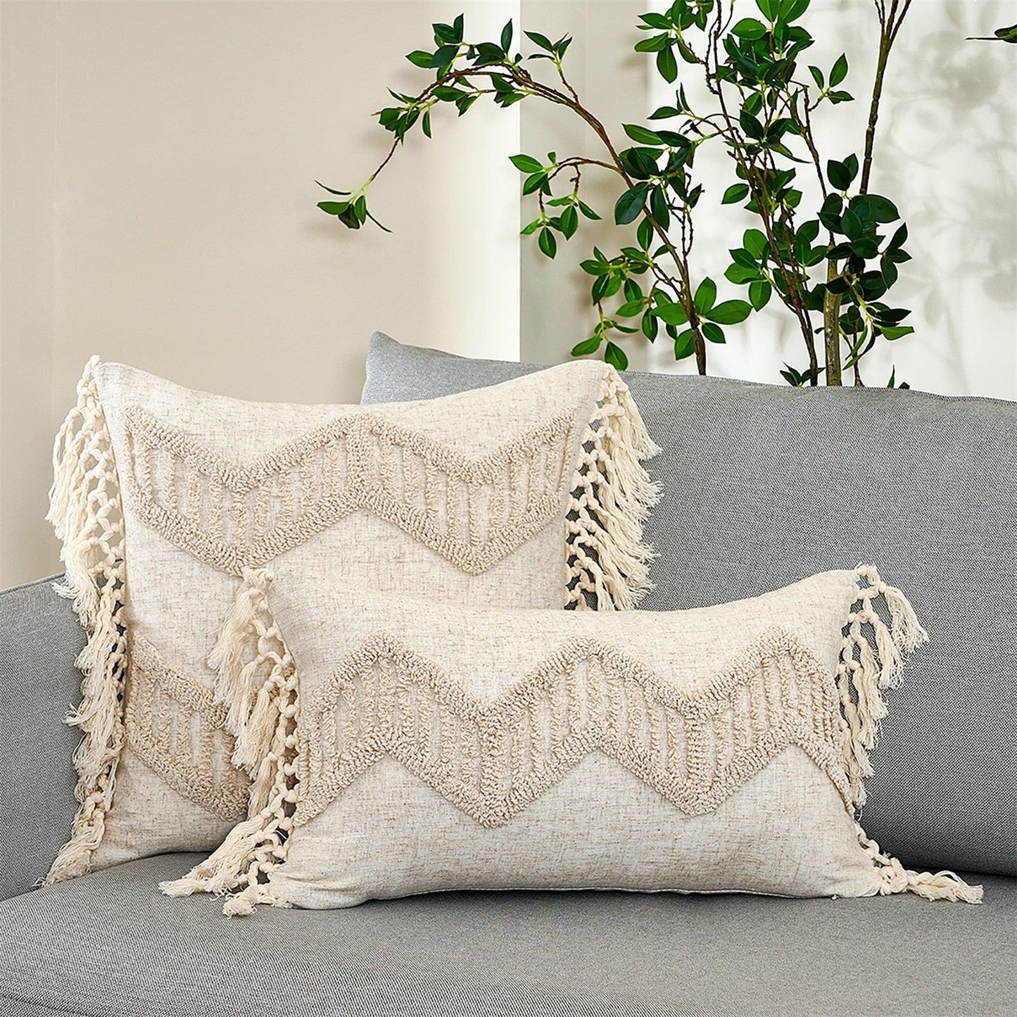 Two beige cushion covers tufted hand-woven cotton-linen with fringe tassels on a grey sofa on Tampa Home & Garden Store