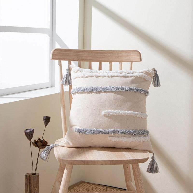 Cushion cover beige cotton-linen with tufted stripes and tassel accents on a wooden chair on Tampa Home & Garden Store